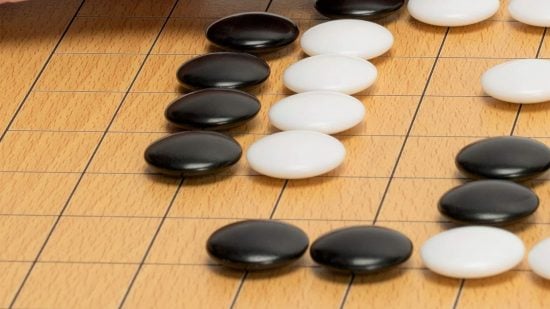 How to play Go rules - photo of black and white Go stones