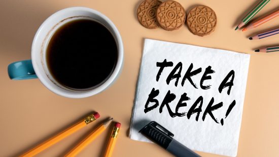 Losing at Warhammer 40k - stock photo showing a cup of coffee, pencils, and cookies, with a written note reading "take a break"