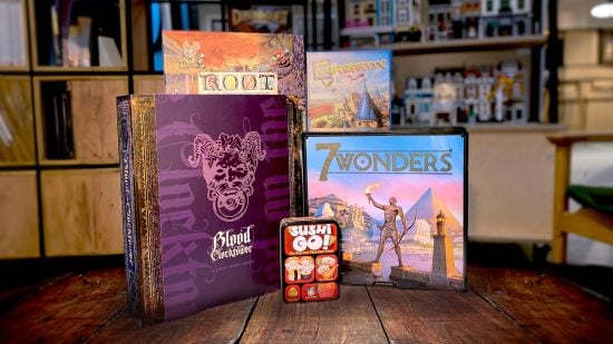 Best board games guide - Wargamer photo showing several board game boxes on a table at the Network N office, including Blood on the Clocktower, 7 Wonders, Sushi Go, Root, and Carcassonne - with Lego in the background