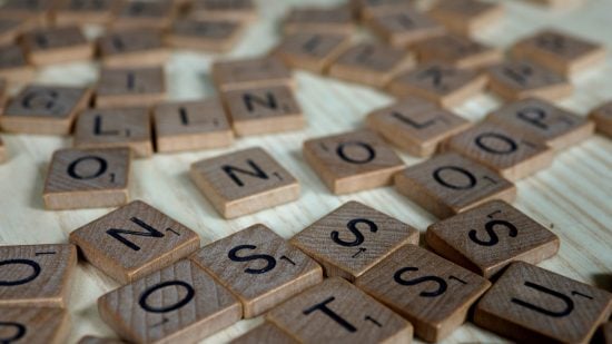 A bunch of scrabble tiles laid out across a table.