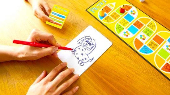 How to play Pictionary - photo of a hand drawing a dog in Pictionary