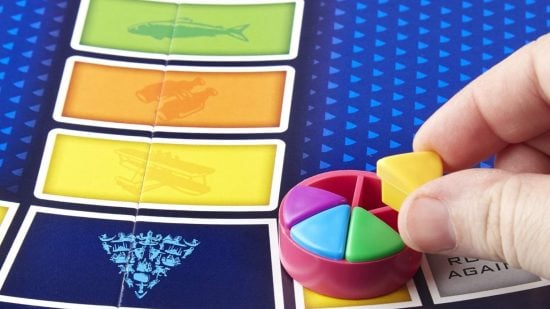 How to play Trivial Pursuit - photo of someone placing a wedge in a Trivial Pursuit player piece