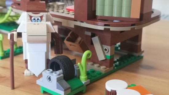 Lego Donkey Kong's Tree House review image showing Cranky near a tire.