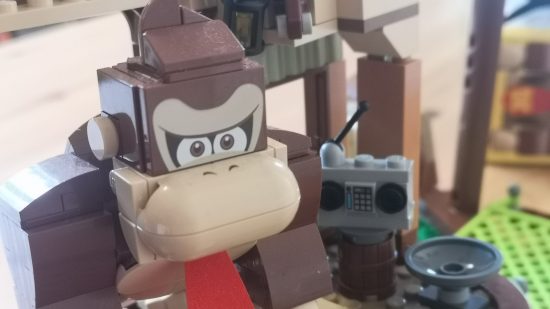 Lego Donkey Kong's Tree House review image showing DK inside the tree house near a cassette player.