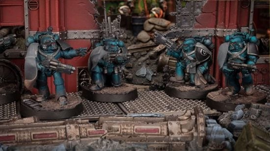 Warhammer 40k Alpha Legion headhunters in green power armor crouch in ruins