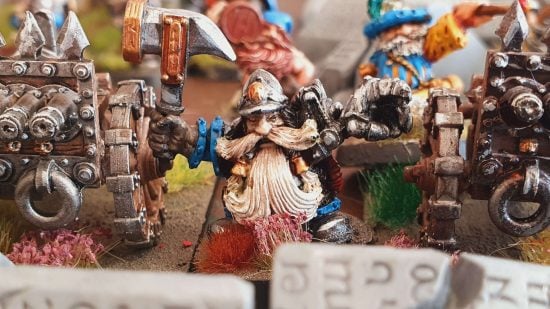 Warhammer the Old World Dwarf Engineer stands in between two organ guns