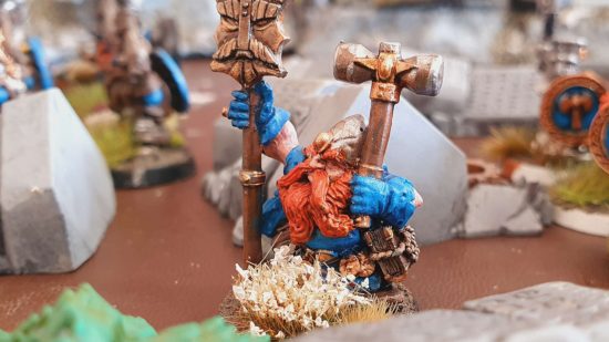 Warhammer the Old World dwarf rune priest holding a hammer and a staff