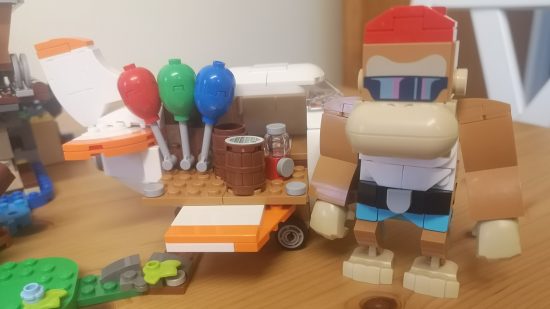 Lego Donkey Kong: Diddy Kong's Mine Cart Ride review image showing Funky at his shop.