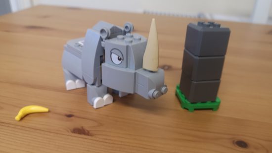 Lego Donkey Kong: Rambi the Rhino review image showing Rambi near a pillar and a banana.