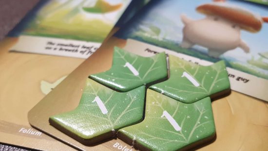 Mycelia review - four green leaf tokens, the game's currency