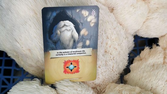 Mycelia review - a game card depicting an anthropomorphic tiered tooth fungus, resting on a bed of lionsmane mushrooms