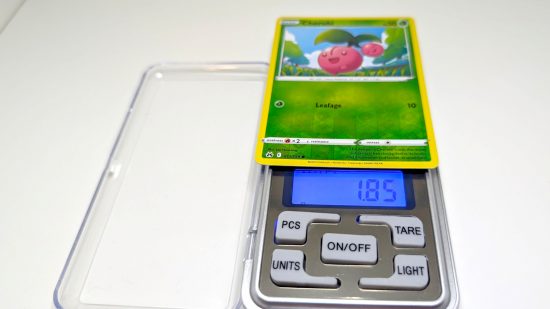 Pokemon card size and weight guide - Wargamer photo showing a reverse holo Cherubi card being weighed