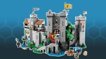 The best Lego castles - the Lego Lion Knight's castle, a grey castle with a keep, portcullis, banners, and a knight standing in the gateway