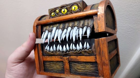 3D printed model of a DnD mimic, a chest with a row of fangs and four yellow eyes