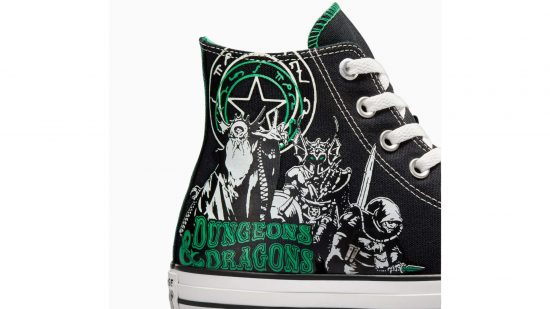 Black Converse DnD sneakers with a white print of three old-school DnD characters and the DnD title in green font