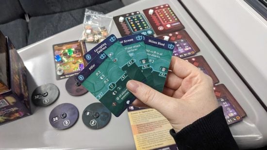 Gloomhaven Buttons & Bugs board game on a train travel table
