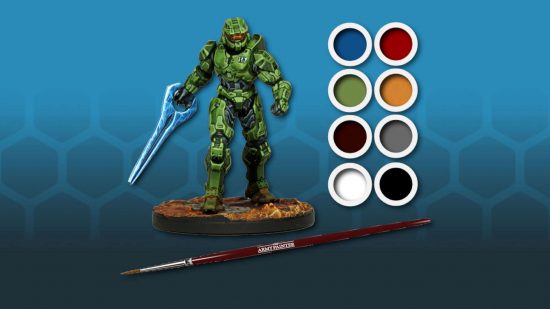 Halo Flashpoint Master Chief model - a Spartan in green power armor with an orange visor holding a power blade, next to a selection of paints and a paintbrush