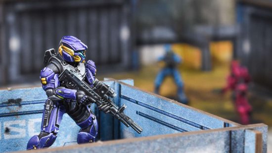 Halo Flashpoint - a Spartan Sniper in purple armor overlooks the battlefield from their vantage