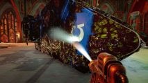 Warhammer 40k Power Wash Simulator DLC screenshot - the player sprays the side of a Land Raider battle tank using a hose, revealing an Ultramarines icon
