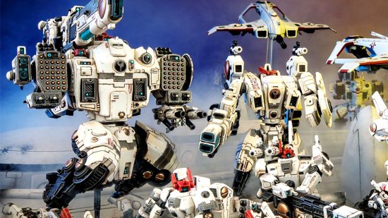 Warhammer 40k T'au Empire Codex - photograph of a collection of different marks of huge white battle-suit, equipped with high powered ordnance