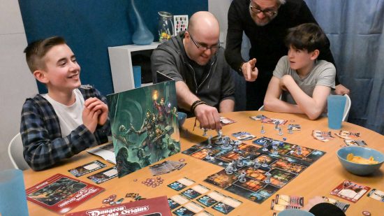 A mixed age group playing the dungeon crawler board game Dungeon Saga Origins