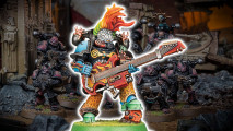 Warhammer 40k Noise Marines index - a luridly colored power-armored warrior wielding a massive electric guitar