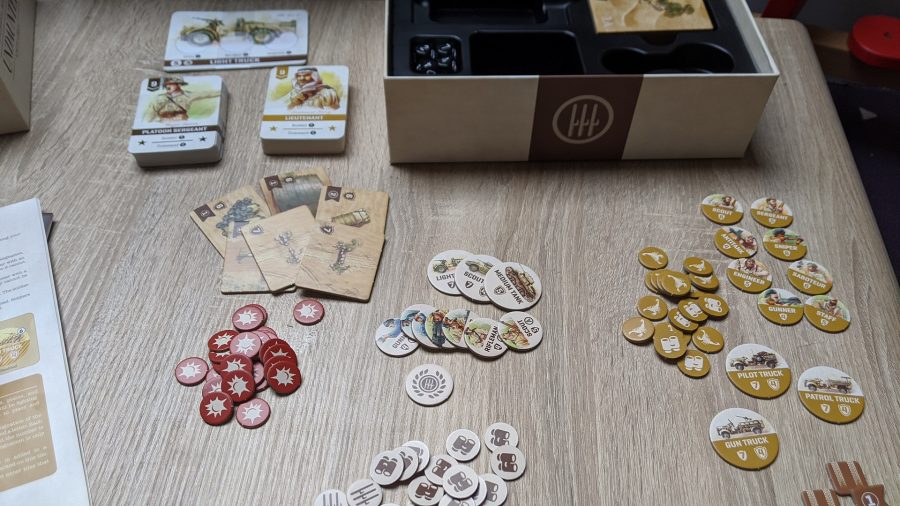 a shot of the box and the game's components laid out on a table