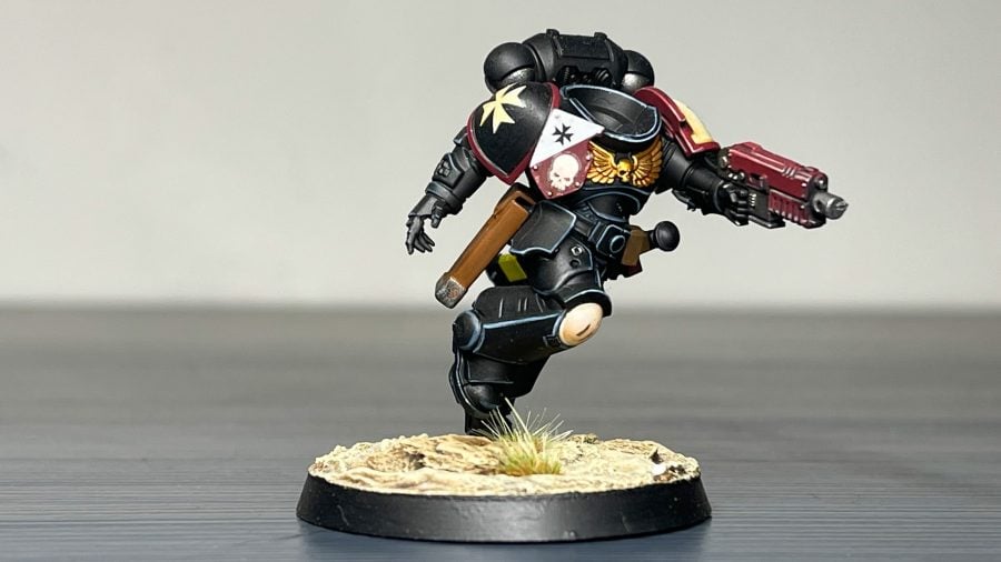 Painting miniatures guide edge highlighting as shown on a headless black templar space marine