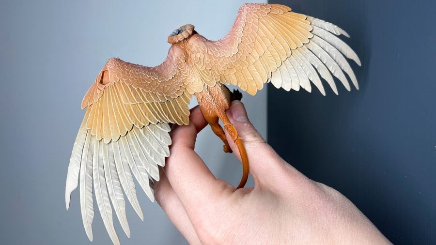 Painting miniatures guide drybrushing as shown by the feathers on a lumineth sphinx creature