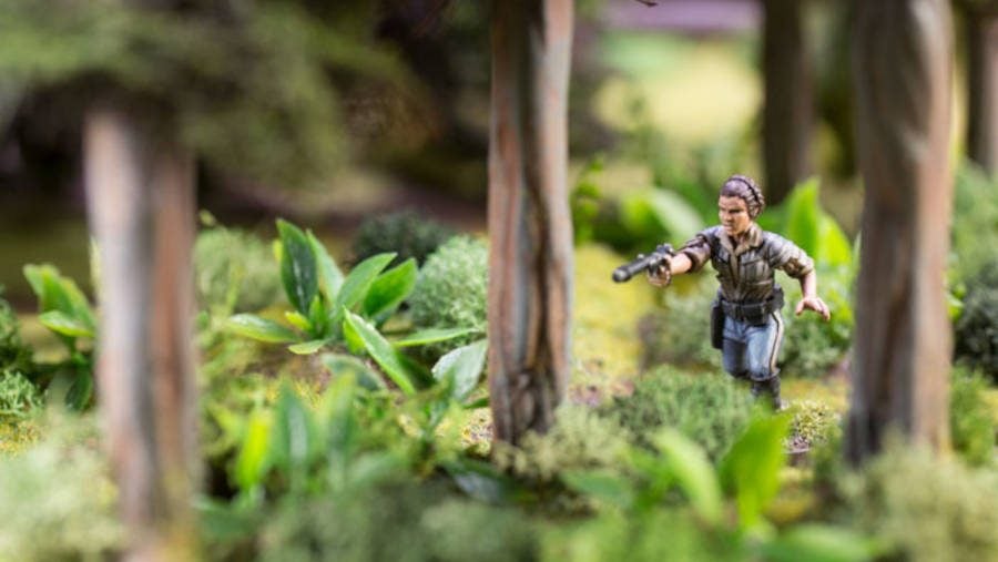 The miniature from the Leia Organa Star Wars: Legion expansion pack positioned amongst shrub terrain