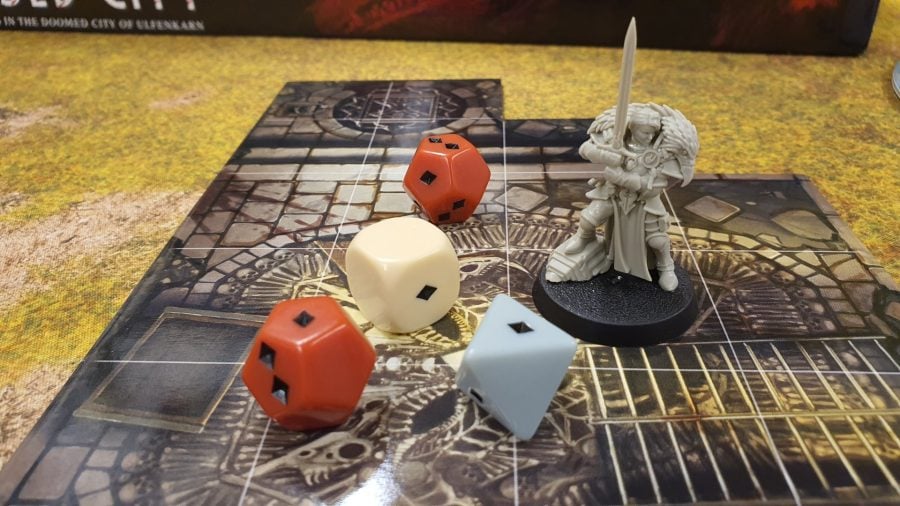 Photo of the model of Emelda Brasko and dice on a board tile from Warhammer Quest Cursed City
