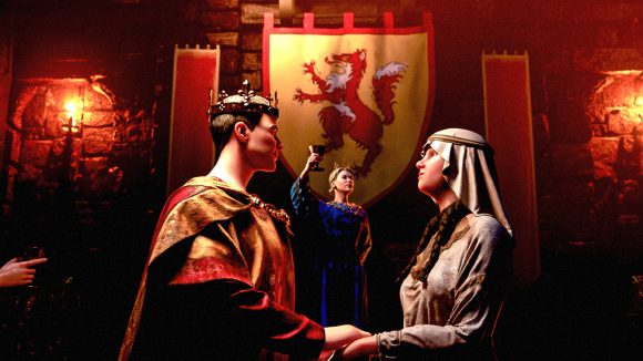 A medieval prince and princess in Crusader Kings 3 holding hands during a marriage ceremony