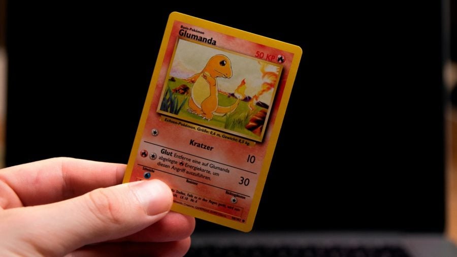 Photo of a charmander pokemon card held in a hand against a black backrgound - credit to Thimo Pedersen / Unsplash