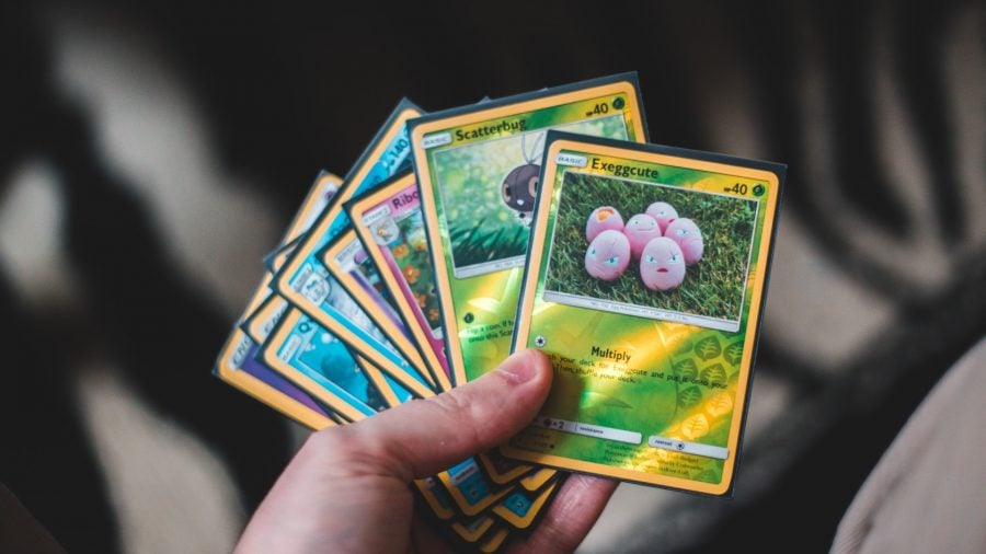 Photo of a full hand of Pokemon TCG cards, with an Eggxecute up front - credit to Erik McLean / Unsplash