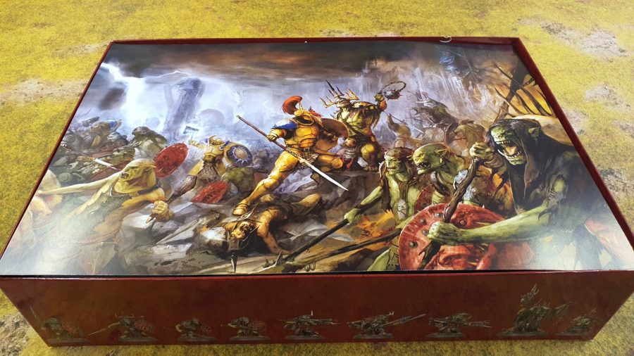 Photo of the art insert inside the box for Age of Sigmar Dominion, showing Stormcast Eternals and Kruleboyz in combat