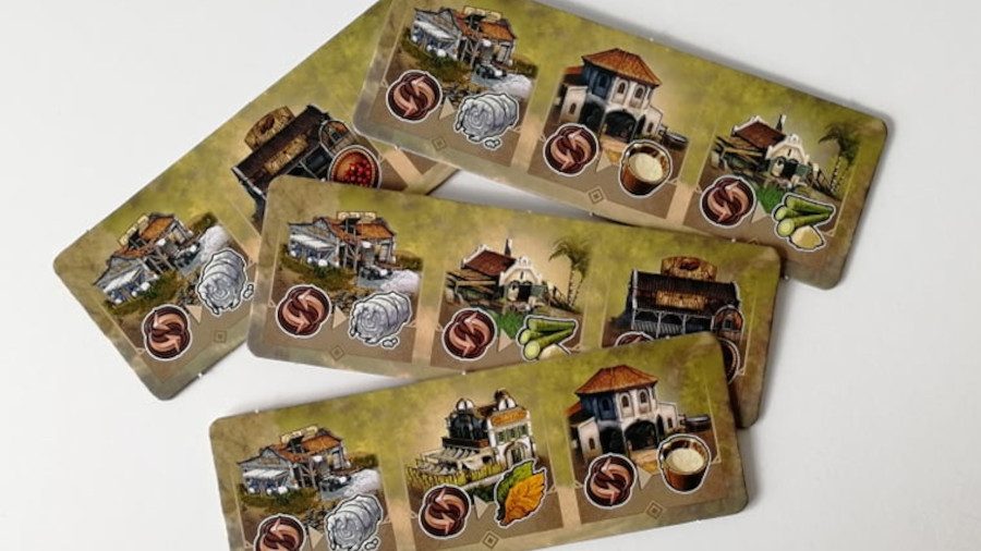 Anno 1800 board game tile pieces laid across one another