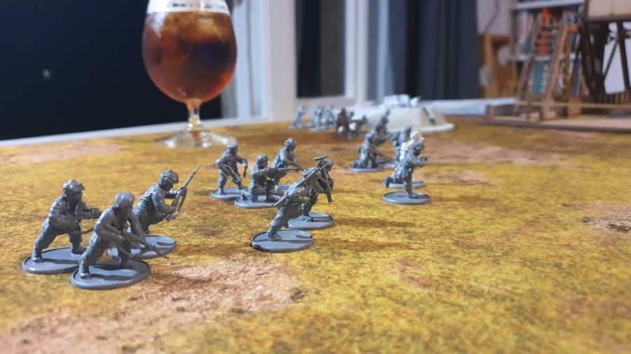 Bolt Action Pegasus Bridge review - photo showing British models arrayed on a table, with a glass of Pimm's in the background