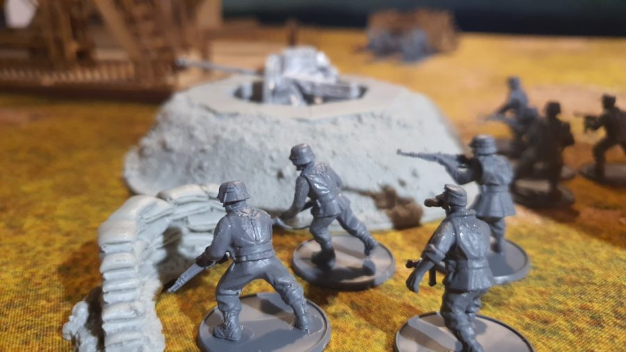 Bolt Action Pegasus Bridge review - photo showing German infantry models in cover by an AT gun emplacement