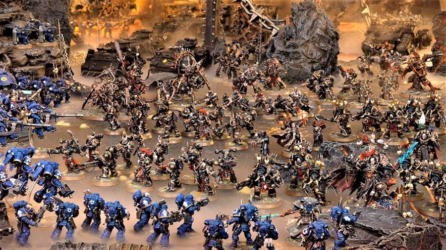 Warhammer 40k Chaos Space Marines faction guide Warhammer Community photo showing a large chaos space marines army fighting Ultramarines