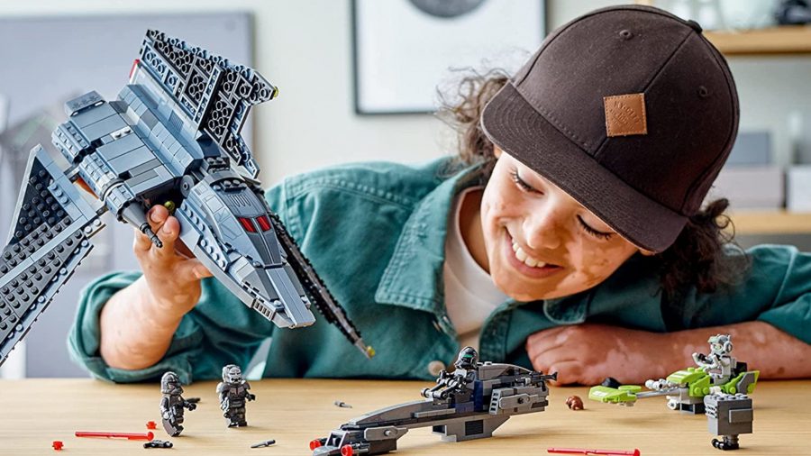 Best Star Wars Lego Sets a child playing with the Bad Batch Attack Shuttle set