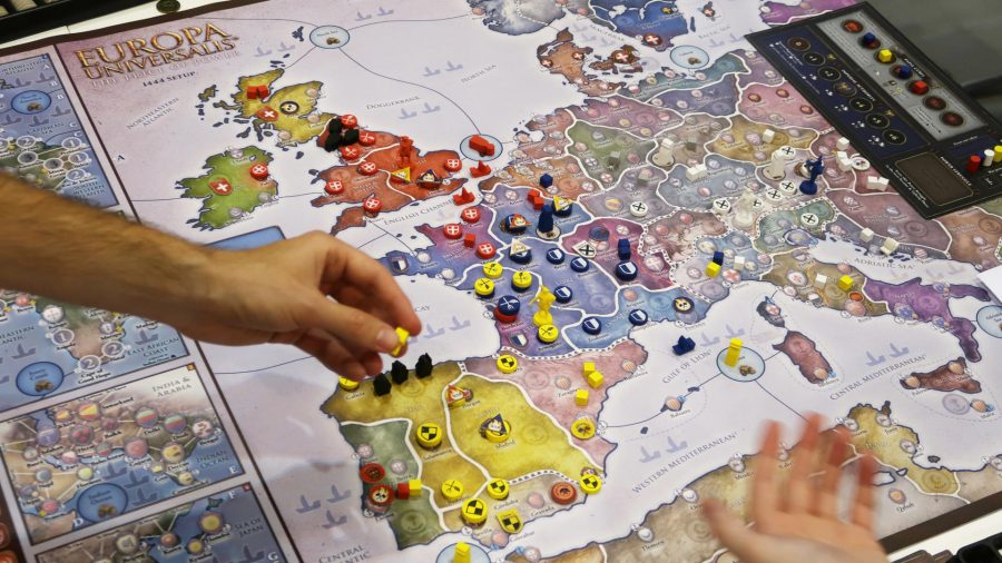 Europa Universalis: The Price of Power board game a hand moving tokens around the central map