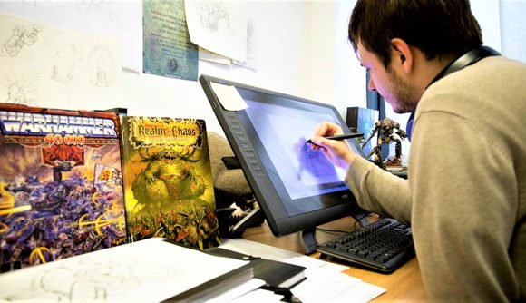 Games Workshop jobs Miniatures Conceptualiser - Warhammer Community photo showing a Citadel Miniatures Conceptualiser at work at a design tablet computer