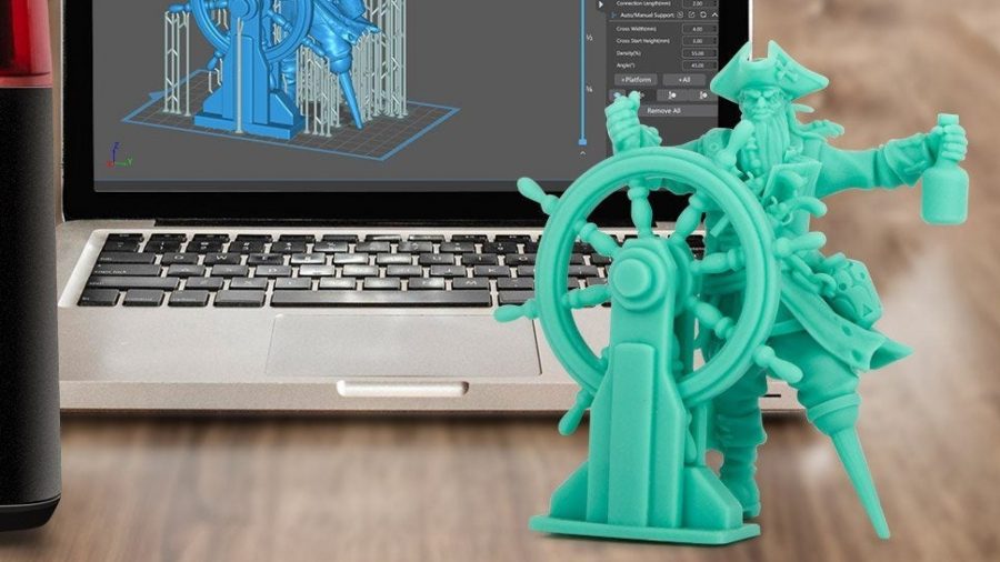 Best 3D printers for miniatures: a 3D printed model pirate on a table, beside a laptop showing the software it was designed on