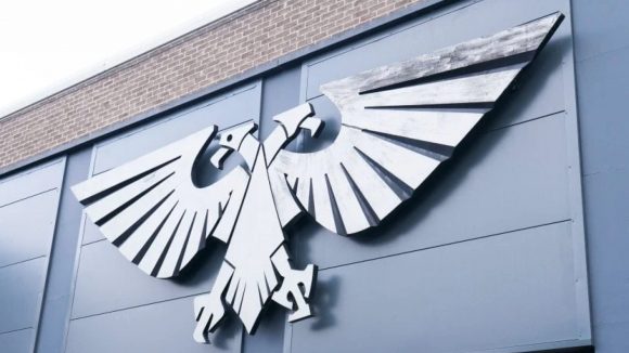 Warhammer 40k Games Workshop jobs Head Writer - GW official photo showing the metal Aquila on the wall of Warhammer World HQ in Nottingham, UK