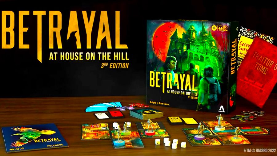 Betrayal at House on the Hill 3rd edition review - the board game box, rulebooks, and components spread out on a table with the Betrayal at House on the Hill logo in the top left