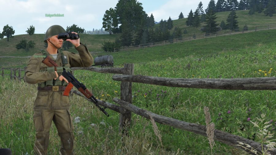 Arma 4 reforger hands on: a soldier looking through binoculars across a field