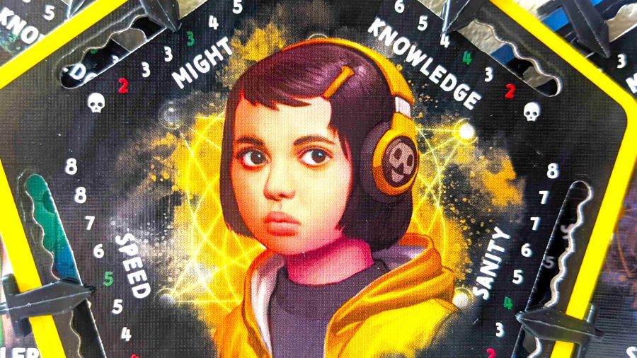 Betrayal at House on the Hill 3rd edition review - a small girl wearing headphones printed on a pentagonal piece of carboard, with 'might, 'speed', 'sanity', and 'knowledge' written around her