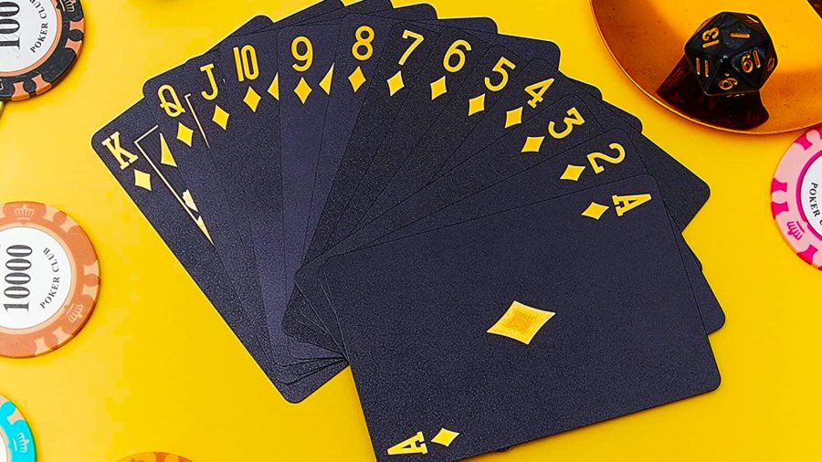 How to play solitaire - hand full of black cards with gold lettering
