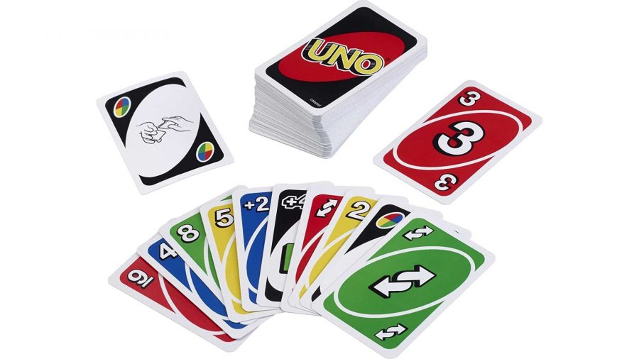 Uno rules - deck of uno cards and a hand of multicoloured uno playing cards
