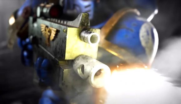 Games Workshop new Warhammer paints - Warhammer Community trailer screenshot showing a space marine bolt rifle being coloured with paint